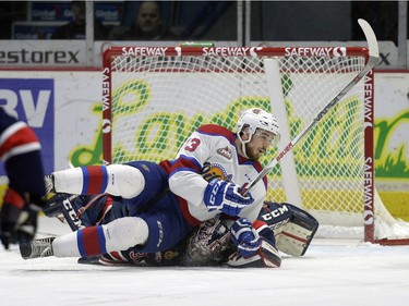 Regina Pats goalie Tyler Brown (31) is squashed by Edmonton Oil Kings forward Brandon Baddock (13) in front of the net during a game held at the Brandt Centre in Regina on Sunday Feb. 21, 2016.