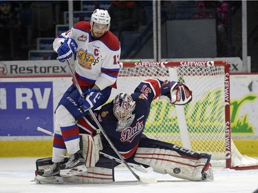 Regina Pats goalie Tyler Brown makes the save as Brandon Baddock of the Edmonton Oil Kings falls on top of him during WHL action on Sunday at the Brandt Centre.
