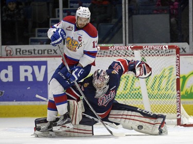 Regina Pats goalie Tyler Brown makes a save while Edmonton Oil Kings forward Brandon Baddock is about to fall backward on top of the net minder during a game held at the Brandt Centre in Regina on Sunday Feb. 21, 2016.