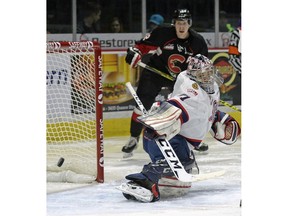 Regina Pats goalie Tyler Brown steers the puck away from the net during a WHL game against the Prince George Cougars on Saturday.