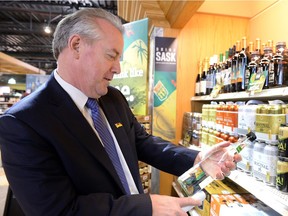 Don McMorris, minister responsible for SLGA, looks over product at South Albert Liquor store in Regina on April 23, 2015.