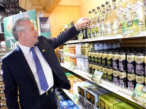 Don McMorris, minister responsible for SLGA, looks over Saskatchewan product at the South Albert Liquor store in Regina on April 23, 2015.