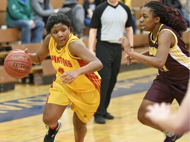 Sydney Teece (L) of the Sheldon-Williams Spartans and Keyara Donaldson (R) of the LeBoldus Golden Suns during a basketball game at the Rochdale Invitational Tournament in Regina on February 04, 2016.