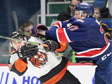 Austin Wagner (R) with the Regina Pats nails Tyler Preziuso (L) with the Medicine Hat Tigers during WHL hockey action at the Brandt Centre in Regina on February 05, 2016.