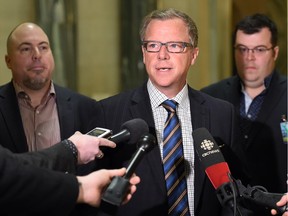 REGINA SK: FEBRUARY 08, 2016 -- Chairman of Weyburn based Valleyview Petroleums Ltd., Dan Cugnet (L) and his brother, Matt Cugnet (R) president, along with Saskatchewan Premier Brad Wall (C) speak to the media during a scrum at the Saskatchewan legislative building rotunda in Regina on February 08, 2016 regarding federal funding to clean-up of oil wells no longer capable of production.  (DON HEALY)