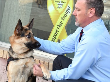 Chris Siddons, an operational stress injury co-ordinator with veteran assist service dog, Sierra at the Royal Canadian Legion Provincial Command's office in Regina on February 17, 2016.