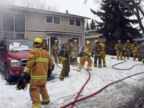 Firefighters at the scene of a house fire at 117 Milne St. on Feb. 18, 2016.