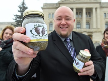 Terry Bell, Saskatchewan NDP candidate for Regina Walsh Acres out front of the Saskatchewan Legislative building with jars of dirt priced at $300 each to represent what the NDP are calling an inflated land price for the $103,000 per acre paid for land for the Global Transportation Hub (GTH) by the Saskatchewan Party to businessman.