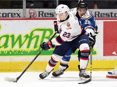 Regina Pats' Sam Steel and Kootenay Ice's Jason Wenzel battle for the puck during WHL hockey action at the Brandt Centre in Regina on February 19, 2016.