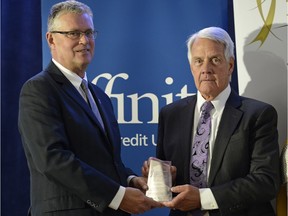 MLA Kevin Phillips, left, presents Kamsack's mayor Rod Gardner with a Saskatchewan Municipal Award during the SUMA convention in Regina on Tuesday. The award was for the town's work developing a recruitment strategy for doctors and creating a health and wellness facility.