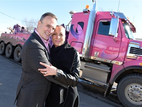 Dionne Warner, an eight-time cancer survivor, with her husband Graham in front of the "Warrior of the Ribbon" tow/rescue truck.