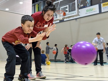St. Jerome Elementary School student Tyson Litzenberger 8 years along with U of Regina student Jessica Rivas trying out bowling as part of a Learning Everyday & Actively Participating (LEAP) program activity at the U of Regina.