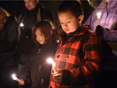 Dayson Raphael (L) and Jesse Caskanette (R) during a vigil being held to draw attention to violence in North Central and elsewhere in Regina.  Core area community members listened to elders speak and sing honour songs and took part in a sweet grass ceremony and made a public call to end violence.