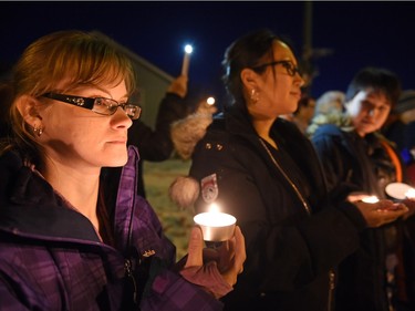 Krystal Lavallee (L), Gayleen Shepherd (C) and Marizah Wahpoosewyan (R) during a vigil being held to draw attention to violence in North Central and elsewhere in Regina.  Core area community members listened to elders speak and sing honour songs and took part in a sweet grass ceremony and made a public call to end violence.
