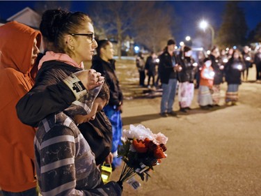 Tara Amyotte comforts Derek Amyotte during a vigil being held to draw attention to violence in North Central and elsewhere in Regina. Derek's father, Derrick Amyotte was murdered in 2012. Tara Amyotte was Derrick Amyotte's sister. Core area community members listened to elders speak and sing honour songs and took part in a sweet grass ceremony and made a public call to end violence.