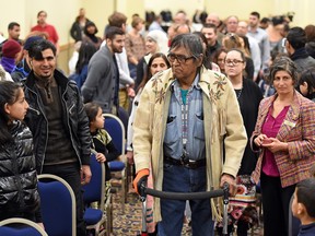 Elder Bob Smoker from the Kahkewistahaw First Nation leads the grand entrance at the "Indigenous Welcome" event" for recent immigrants and refugees.