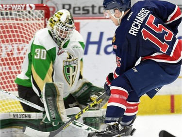 Prince Albert Raiders netminder Rylan Parenteau looks for the puck shot by Pats' Sean Richards.