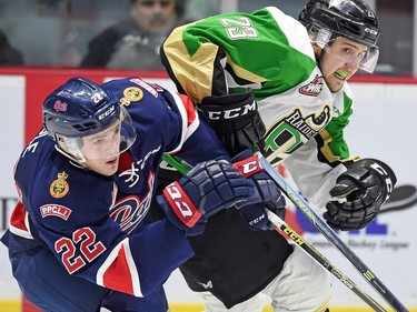 Pats' Rykr Cole and Raiders' Simon Stransky clash.