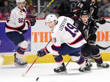 Regina Pats' Jake Leschyshyn and Red Deer Rebels' Michael Spacek battle for the puck during WHL hockey action at the Brandt Centre in Regina on February 29, 2016.