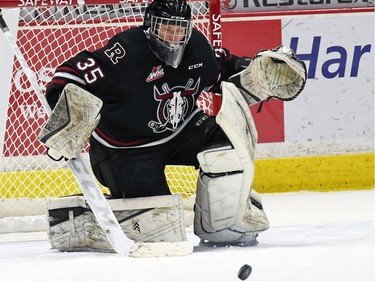 Red Deer Rebels netminder Trevor Martin scrambles for the puck during WHL hockey action against the Regina Pats at the Brandt Centre in Regina on February 29, 2016.