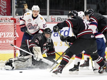 Red Deer Rebels netminder Trevor Martin scrambles for a loose puck in front of the net during WHL hockey action against the Regina Pats at the Brandt Centre in Regina on February 29, 2016.
