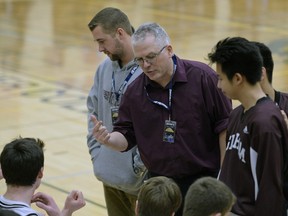 Saskatoon Marion Graham Falcons head coach Dan Dewar talks to his players Thursday during the opening game of the 64th Luther Invitational Tournament.