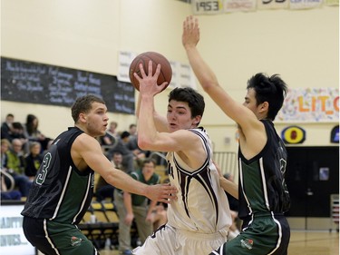 Saskatoon's Alexander Dewar works through Victoria's Madhu McConnell (left) and Chance Harper as the 64th L.I.T. kicks off with Saskatoon's Marion Graham Falcons playing the Victoria Oak Bay Bays.