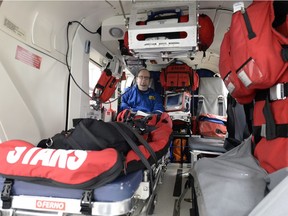 Darcy McKay, clinical operations manager for STARS in Regina, demonstrates where the incubator sits when the helicopter transports a neonatal intensive care team.