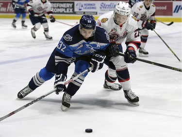 Austin Wagner of the Regina Pats battles with Connor Gay of the Saskatoon Blades during a WHL game on Jan. 29 at the Brandt Centre.