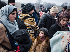Migrants and refugees wait for security check after crossing the Macedonian border into Serbia on Jan. 29.