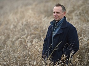 Trevor Herriot, naturalist and author, stands in long grass west of Regina.
