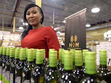Tukwini Mandela stands near a display of House of Mandela wine at an SLGA store on Quance St. in Regina on Monday Feb. 22, 2016.