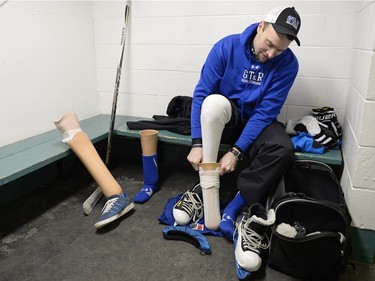 Kelly Downes, a right-foot amputee, changes his prosthetic leg at the White City Communiskate in White City.