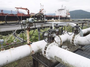 A ship receives its load of oil from the Kinder Morgan Trans Mountain Expansion Project's Westeridge loading dock in Burnaby, British Columbia, on June 4, 2015.