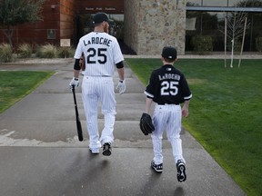 In this Feb. 28, 2015, file photo, Chicago White Sox first baseman Adam LaRoche, left, and his son Drake head for the team's clubhouse before a spring-training workout in Phoenix. The elder LaRoche has gone for another walk, this time in support of his son.