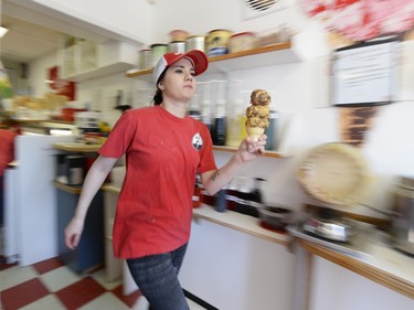 Alicia Totten brings up yet another ice cream cone to the line-ups on the opening day of The Milky Way ice cream shop in Regina at 2:22 p.m. on Sunday March 13, 2016.