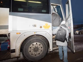 Charles Neil Curly boarding a bus that will take him to Victoria, B.C. He and Jeremy Roy were given one-way tickets to B.C. by the provincial government this week. Both men are homeless.