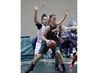 Cougars forward Charlotte Kot about to pivot toward the basket during the second game of a Canada West quarterfinal against the Calgary Dinos in Regina on Saturday March 5, 2016.