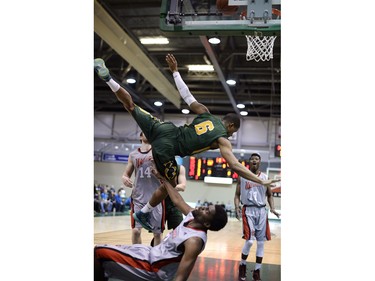 Cougars guard Jonathan Tull (6) goes over Wesmen forward Jelane Pryce (7) during a playoff game held at the University of Regina on Saturday Feb. 27, 2016.