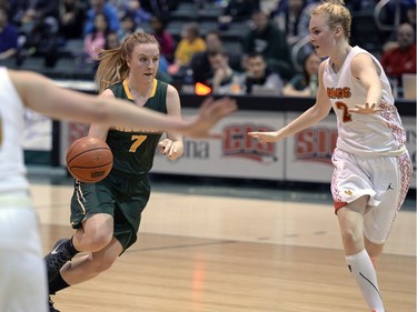 Cougars guard Sara Hubenig (7) drives to the basket while Dinos forward Emma Nieuwenhuizen, 2, tracks her during the second game of a Canada West quarterfinal against the Calgary Dinos in Regina on Saturday March 5, 2016.