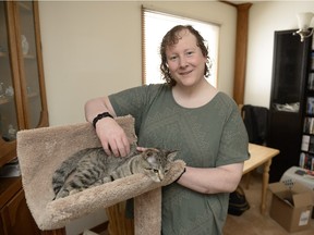 Diane Maguire stands near her cat Cici at her home in Regina on Sunday March 27, 2016. She is a transgender person who came out last year.
