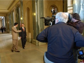 Actors Don McKellar (left), who plays Clarence Fines, and Michael Therriault, playing Tommy Douglas, perform a scene during shooting of The Tommy Douglas Story at the Saskatchewan Legislative Building in 2012.