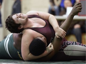 F.W. Johnson Collegiate wrestler Damian Renton, top, holds Campbell Collegiate wrestler Nkemazem Forcheh to the floor in a 115-kilogram match during the Regina High Schools Athletic Association boys wrestling championships at Balfour Collegiate on Saturday.