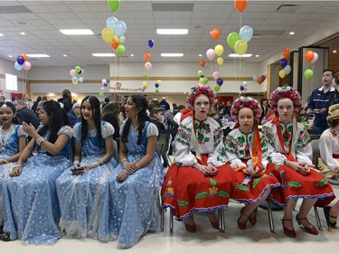 Girls from the Bangla Heritage Language School, left, and girls from the Poltava Ensemble Dancers, right, wait for their chance to perform at the annual Spring Free from Racism event held at the Italian Club in Regina on Sunday March 20, 2016.
