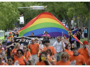 Huge rainbow colours fly during the 2025 Queen City Pride parade in Regina.