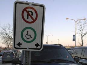 A parking sign in Regina indicating a space reserved for vehicles for people handicapped drivers or passengers.