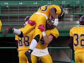 Nick Cross is shown being lifted by LeBoldus Golden Suns teammate Nicholas Dheilly during the 2015 Regina Intercollegiate Football League season. Cross and Dheilly have been invited to play for Team Canada's junior national team at an event in China this summer.