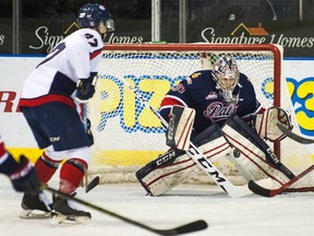 Regina Pats goaltender Tyler Brown looks to make a save in front of Lethbridge Hurricanes' Carter Folk during WHL playoff action Saturday. Brown registered his first WHL playoff shutout as Regina won 3-0 to even a best-of-seven WHL Eastern Conference quarterfinal at 1-1.