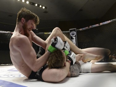 Mariusz Ksiazkiewicz, right, gets an elbow to the head from Micah Brakefield during the Queen City Coronation, an MMA event held at the Orr Centre in Regina on Saturday March 12, 2016.