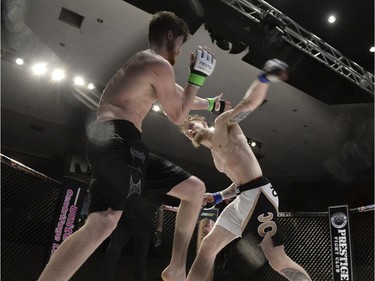 Mariusz Ksiazkiewicz, right, is about to land a punch that moments later would drop Micah Brakefield to the canvas during the Queen City Coronation, an MMA event held at the Orr Centre in Regina on Saturday March 12, 2016.